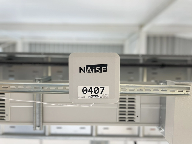 NAiSE UWB anchor mounted on a ceiling structure, used for indoor positioning.