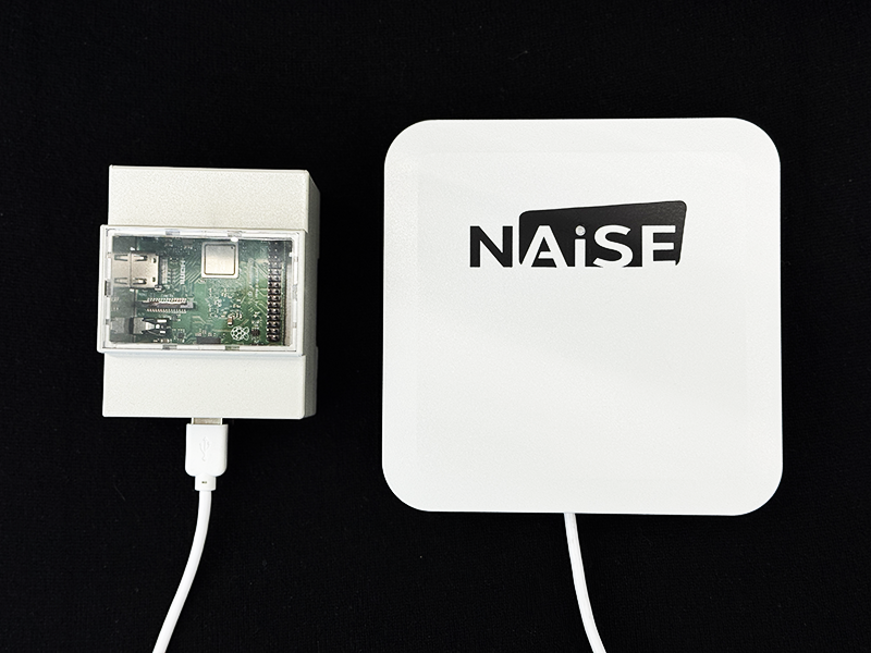 NAiSE UWB gateway device shown with its electronics module and connected cables.