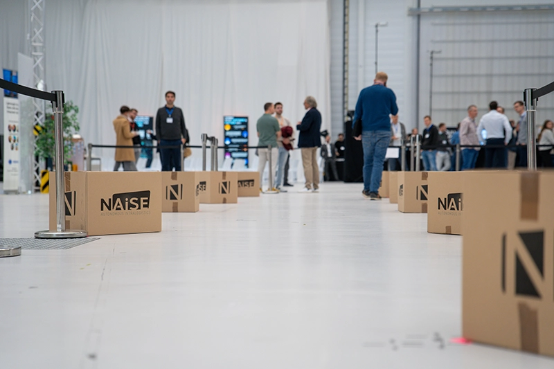 NAiSE Academy branding visual representing hands-on intralogistics platform training for operators, key users, and integrators at ARENA2036 in Stuttgart.”